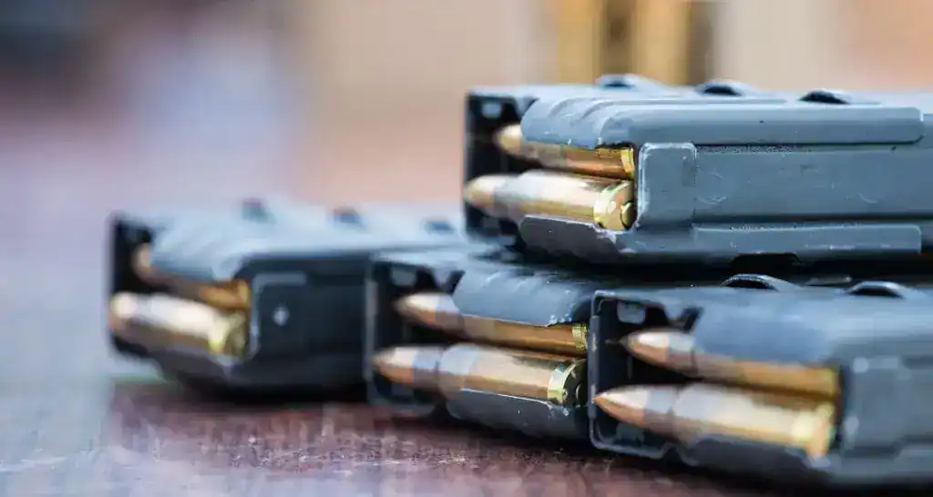 Close-up of loaded firearm magazines with bullets for manufacturing.