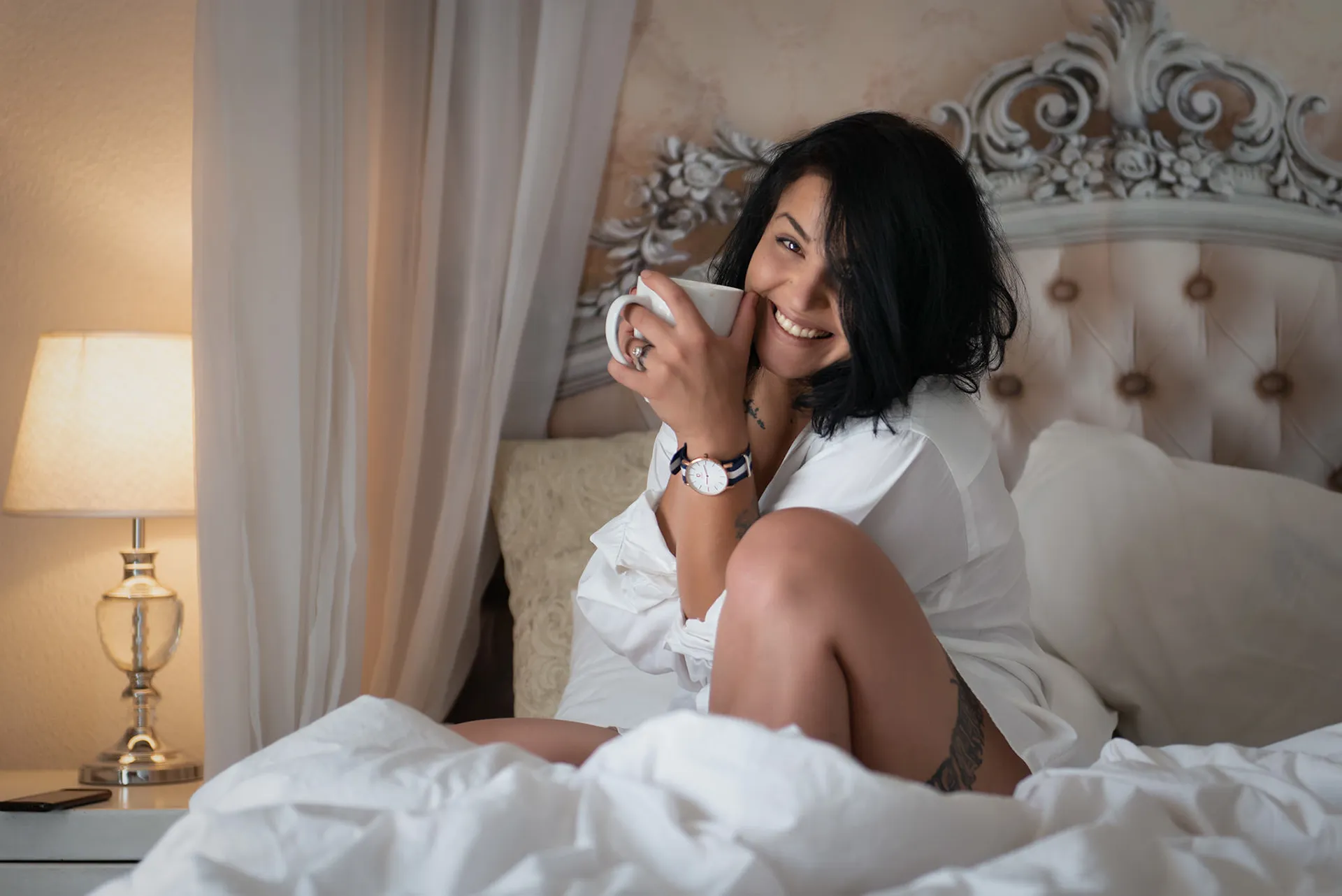 Striking boudoir portrait blending softness and strength, featuring a woman in a contemporary setting that contrasts graceful styling with raw, emotive presence