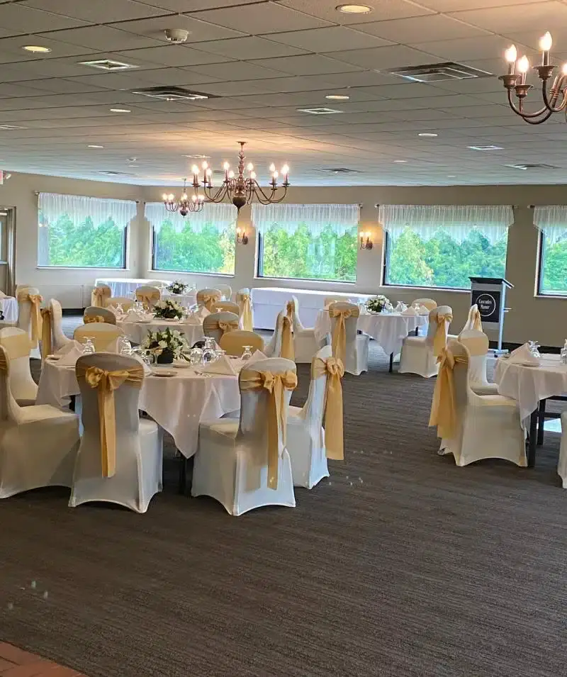 Beautiful indoor event space with large windows and chandeliers.