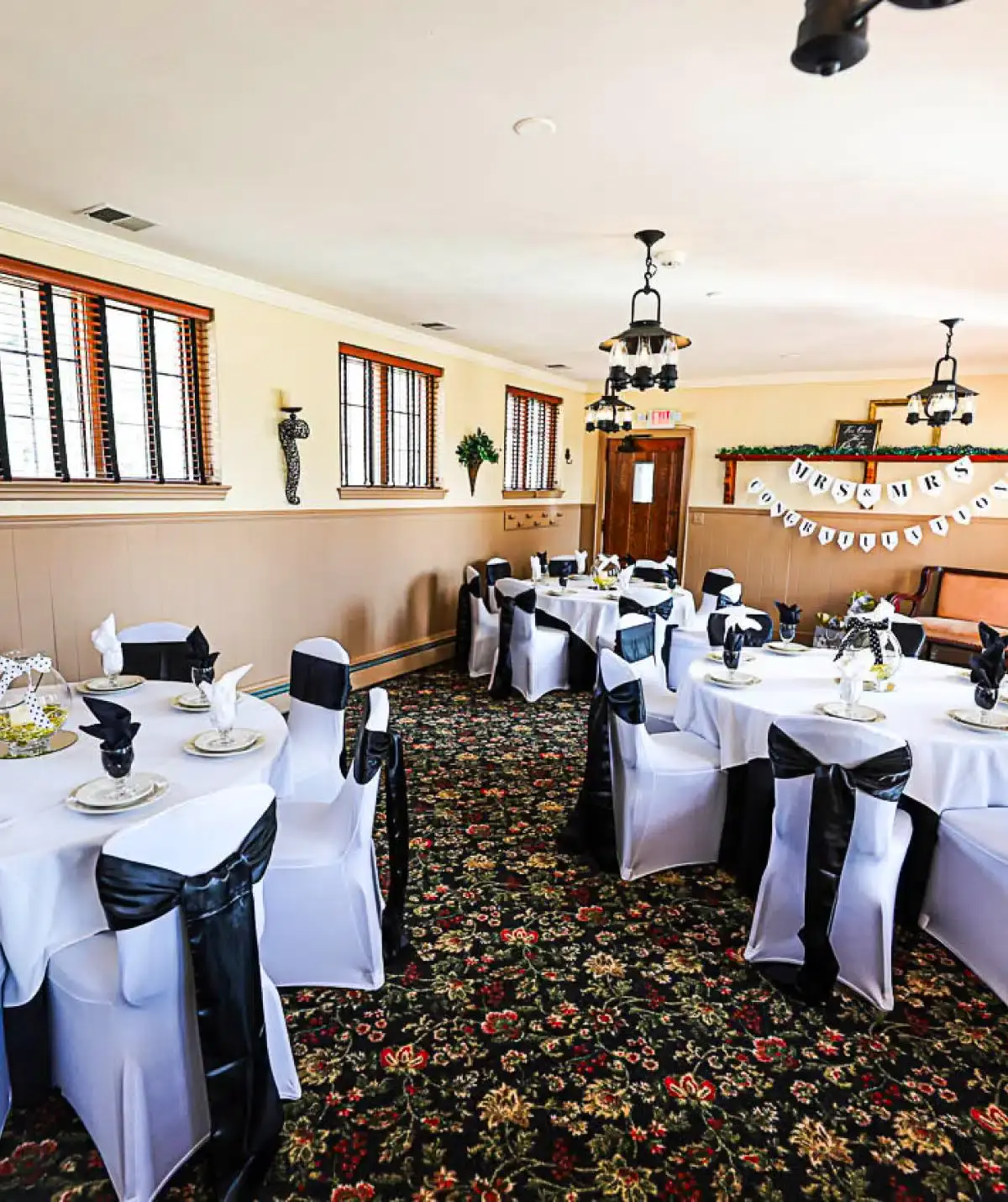 Elegant event space at Cascades Manor with decorated tables and black-and-white accents.