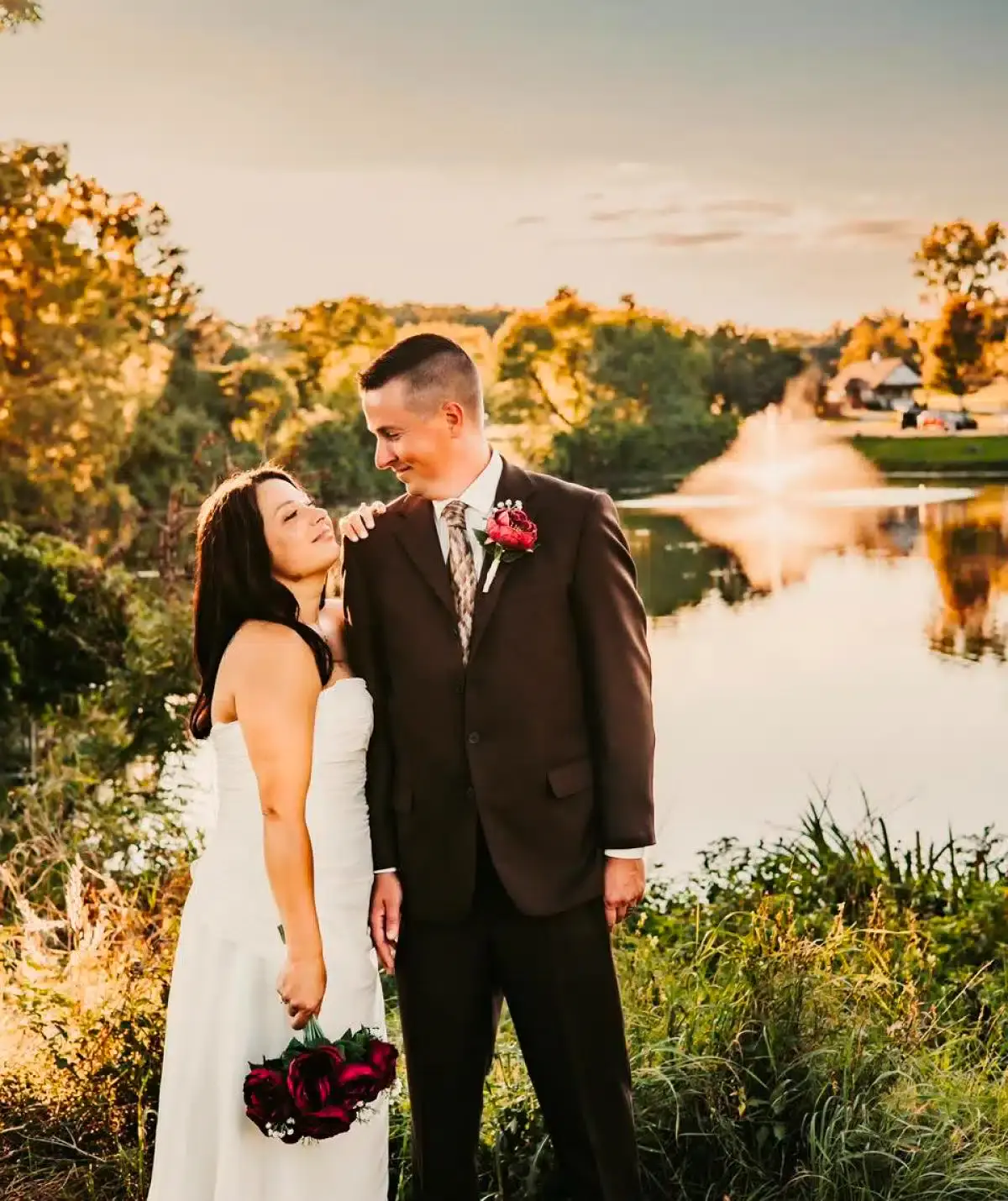Wedding couple at Cascades Manor, outdoor venue with scenic water views.