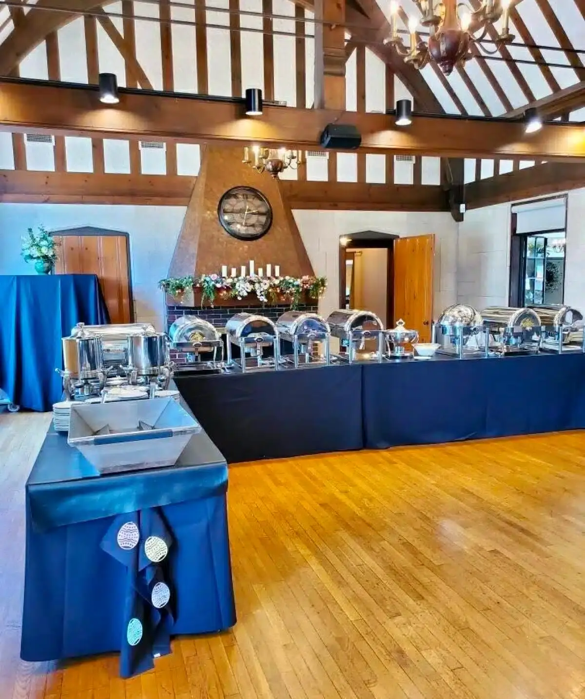 Elegant event setup at Cascades Manor with a long buffet table and rustic interior design.