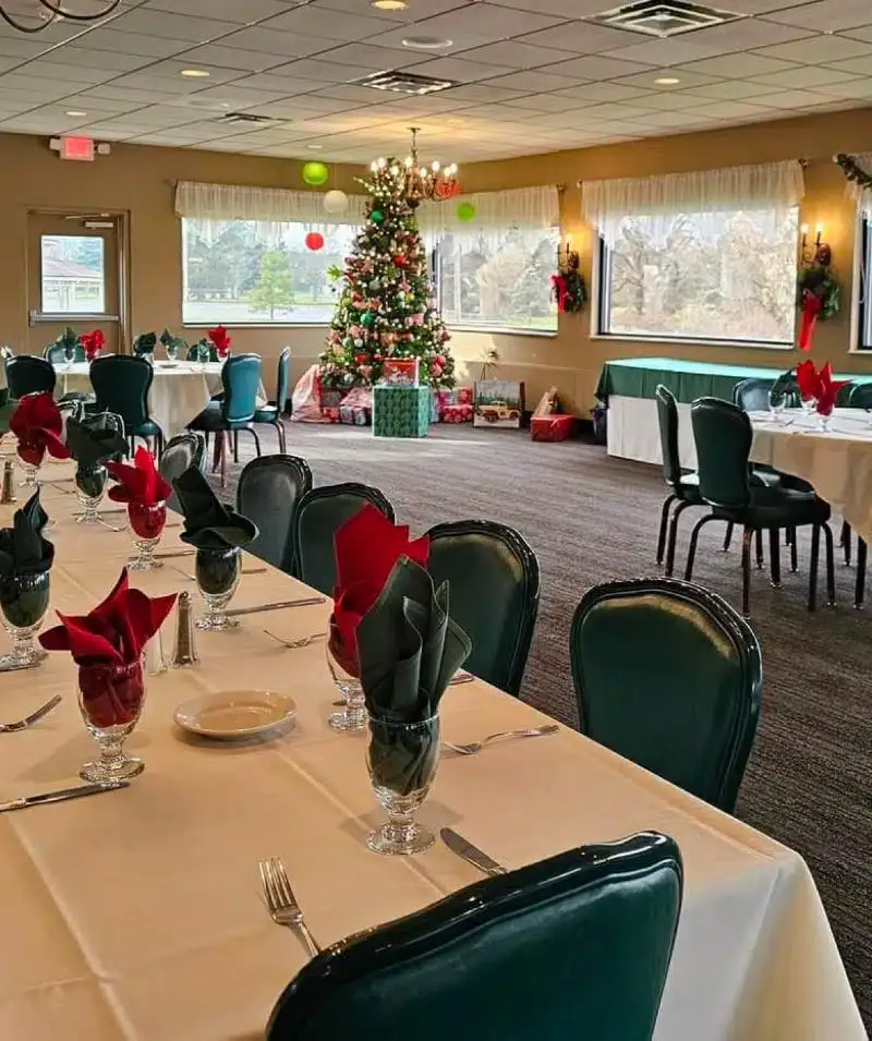 Festive holiday dining room with decorated Christmas tree at Cascades Manor.