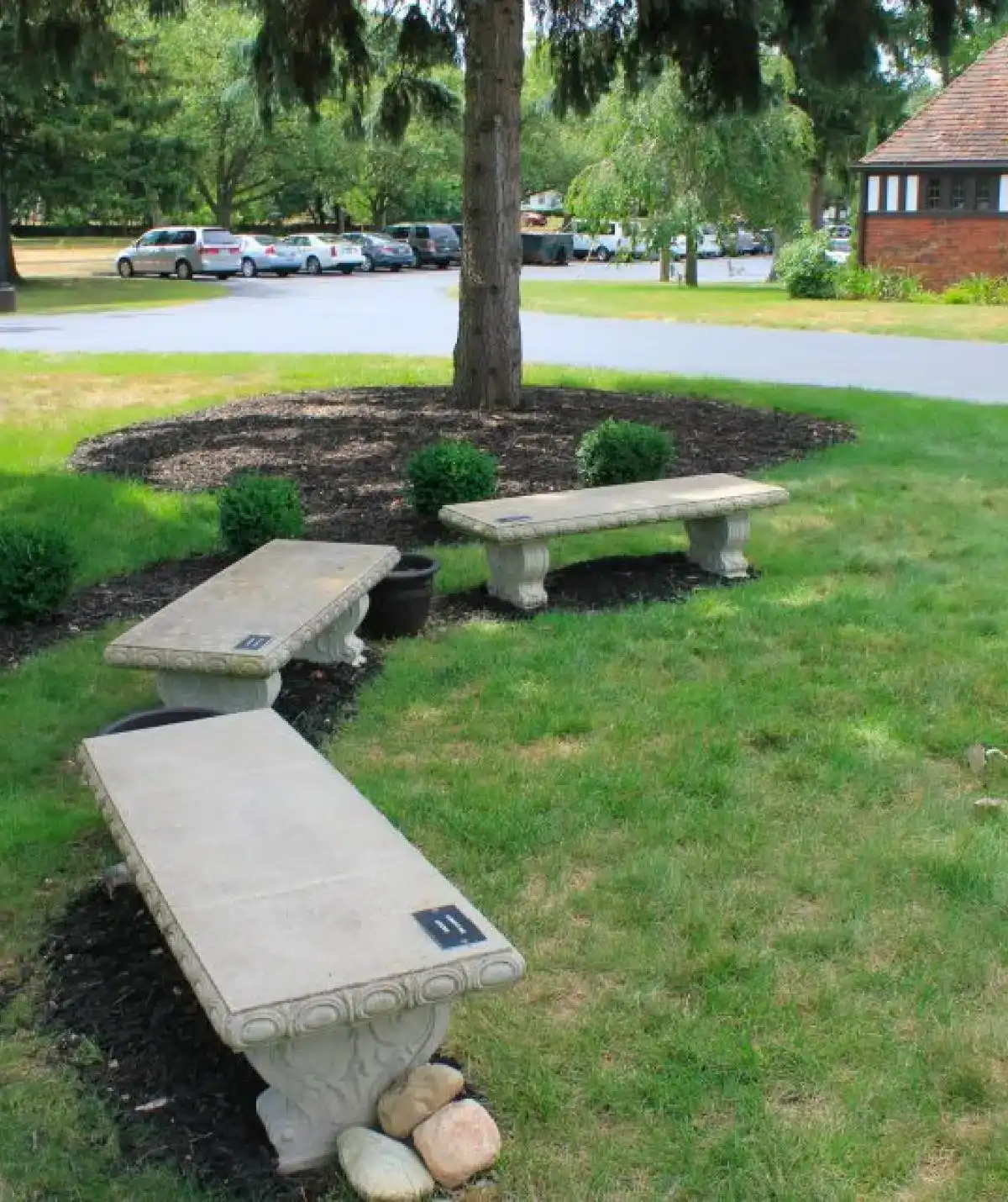 Outdoor benches and landscaped garden area at Cascades Manor.