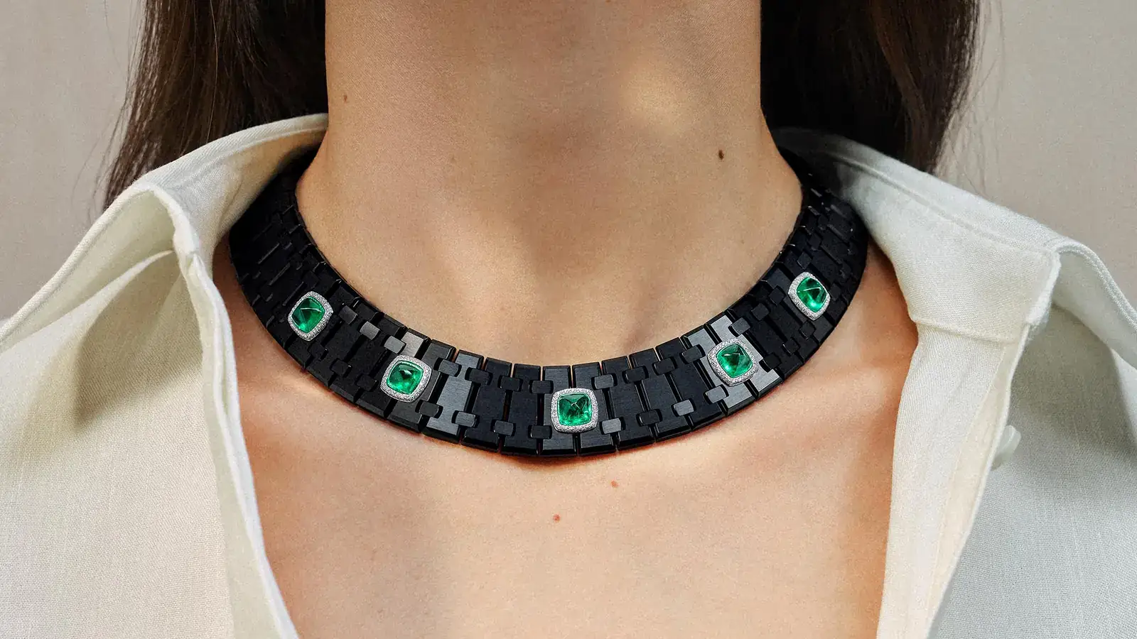 The Risoud Eclipse necklace in black titanium and 18k white gold with five sugarloaf emeralds totaling approximately 16.5 carats / Photo Credit: Audemars Piguet