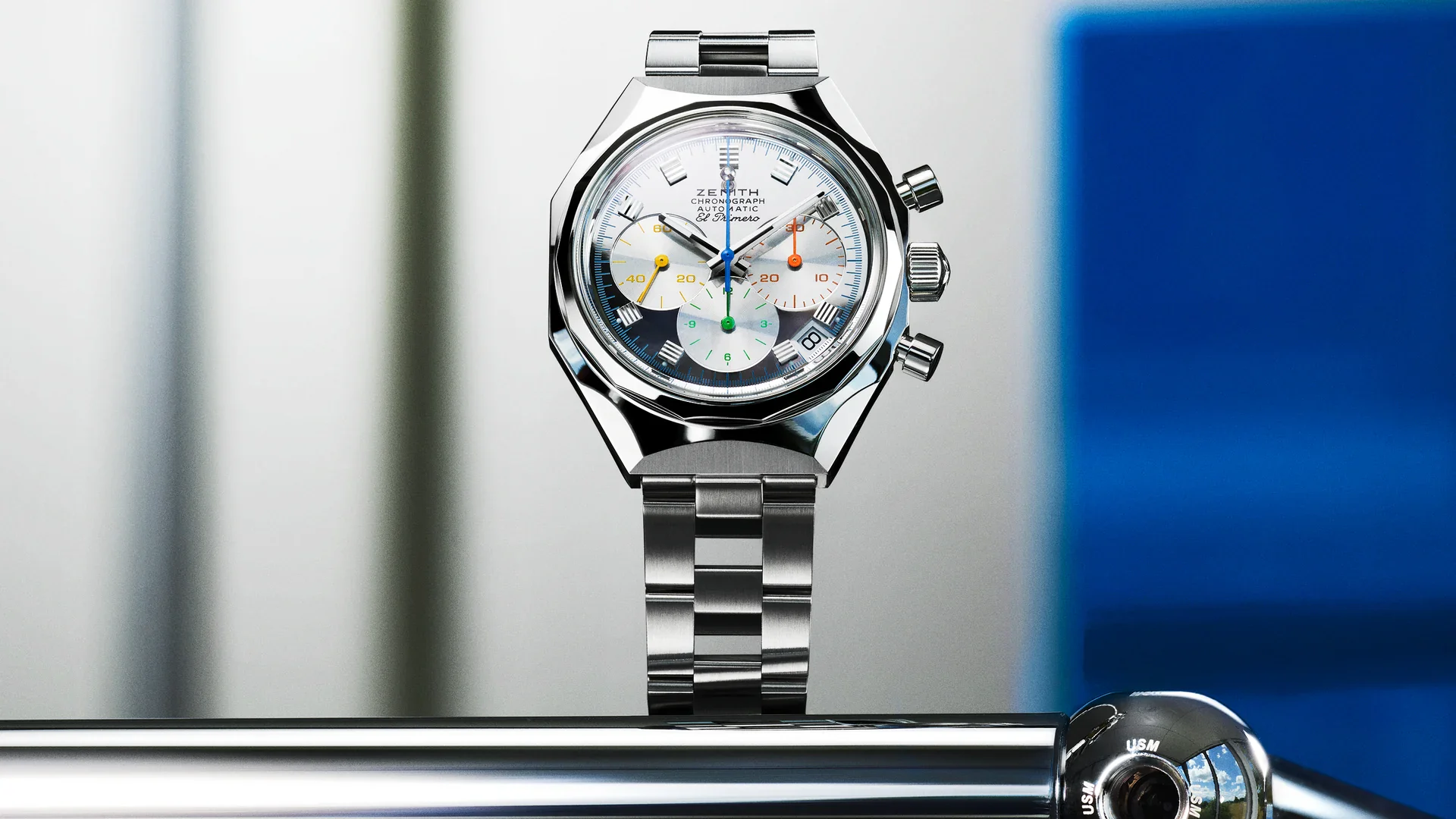 Zenith DEFY Chronograph USM TimeForArt Unique Piece with mirror-polished dial and steel ladder bracelet, standing on a chrome USM Haller frame next to a ball joint