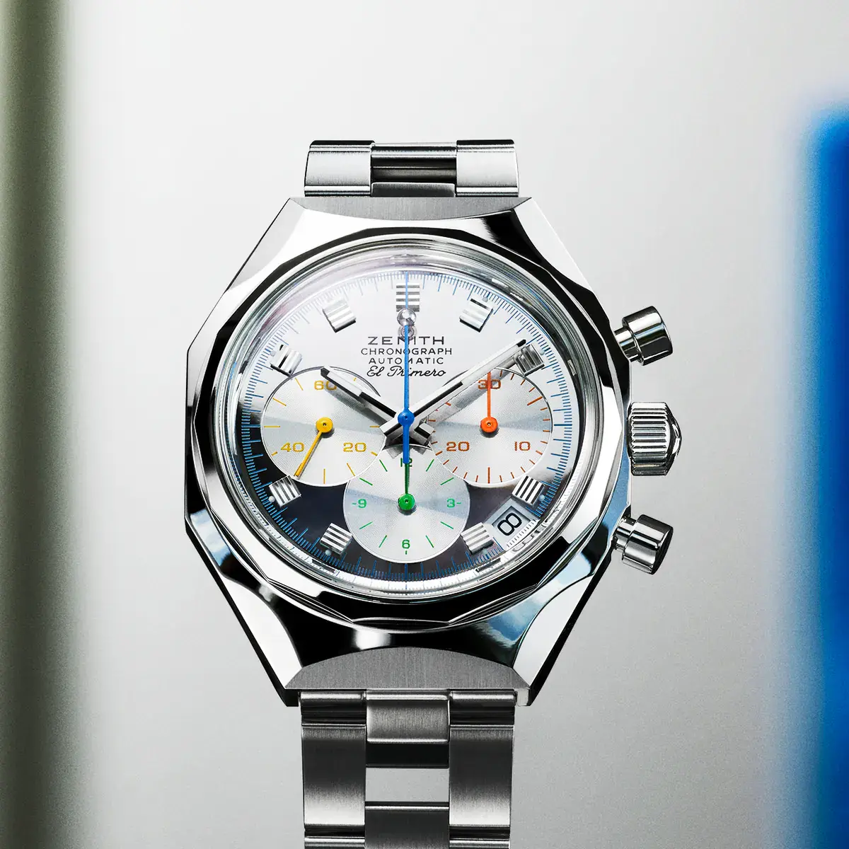 Close view of the Zenith DEFY Chronograph USM TimeForArt Unique Piece mirror-polished dial with yellow, orange, green, and blue counter hands and a blue chronograph seconds hand