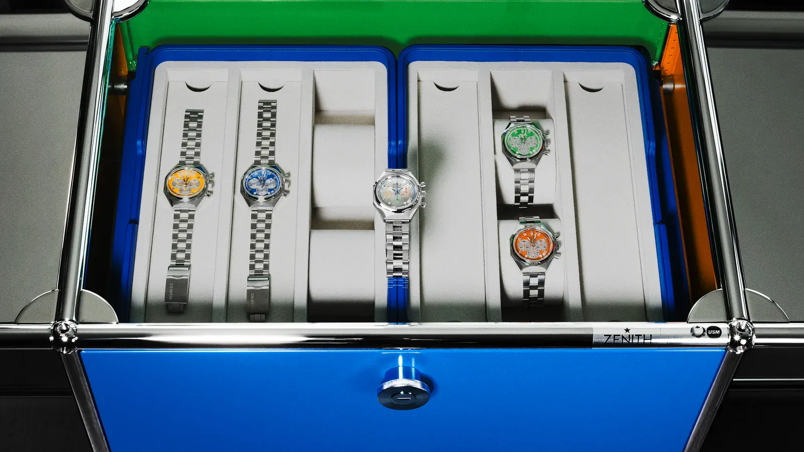 Zenith DEFY Chronograph USM TimeForArt Unique Piece in the USM Haller sideboard drawer beside yellow, blue, green, and orange dial DEFY Chronograph USM watches
