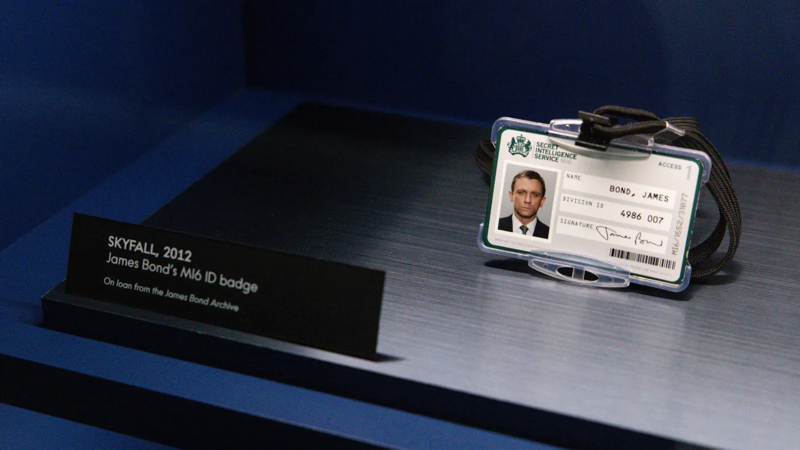 James Bond's MI6 ID badge from Skyfall with its placard, on display at OMEGA Glendale's Timeless Adversaries exhibition for the Omega Seamaster James Bond Spectre collection
