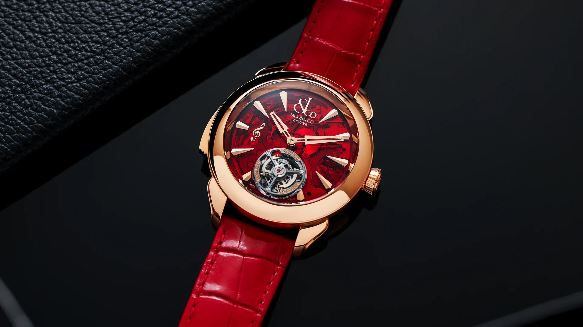 Jacob & Co. Palatial Flying Tourbillon Minute Repeater in 18K rose gold with a red dial and red alligator strap on a dark leather surface