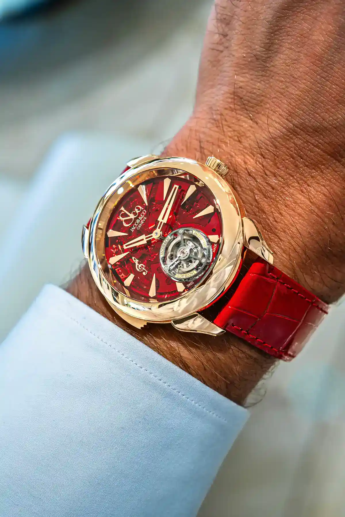 Jacob & Co. Palatial Flying Tourbillon Minute Repeater worn with a white shirt cuff, showing the rose gold case and red dial at an angle