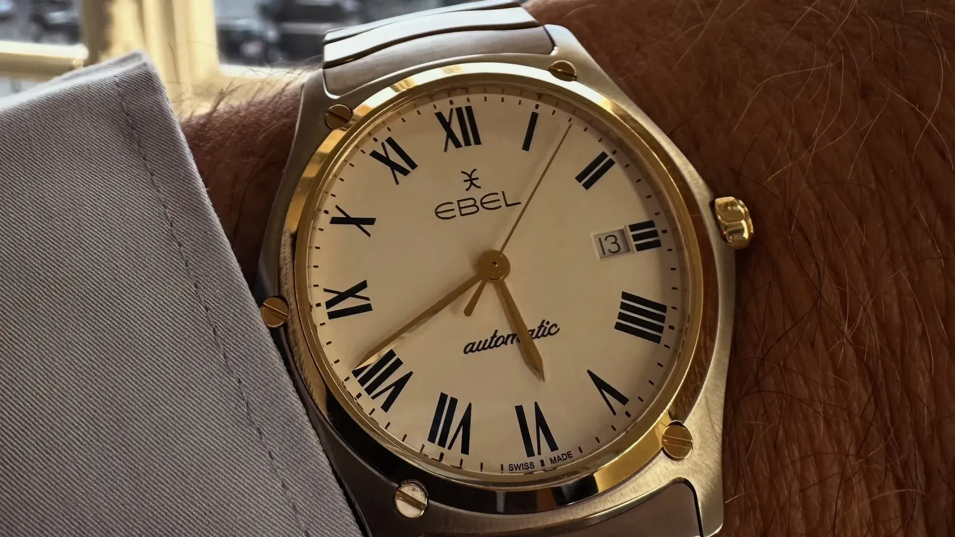 F.P. Journe Chanel Ebel deal: a two-tone steel and gold EBEL automatic with a cream dial, black Roman numerals, and a screwed gold bezel on the wrist