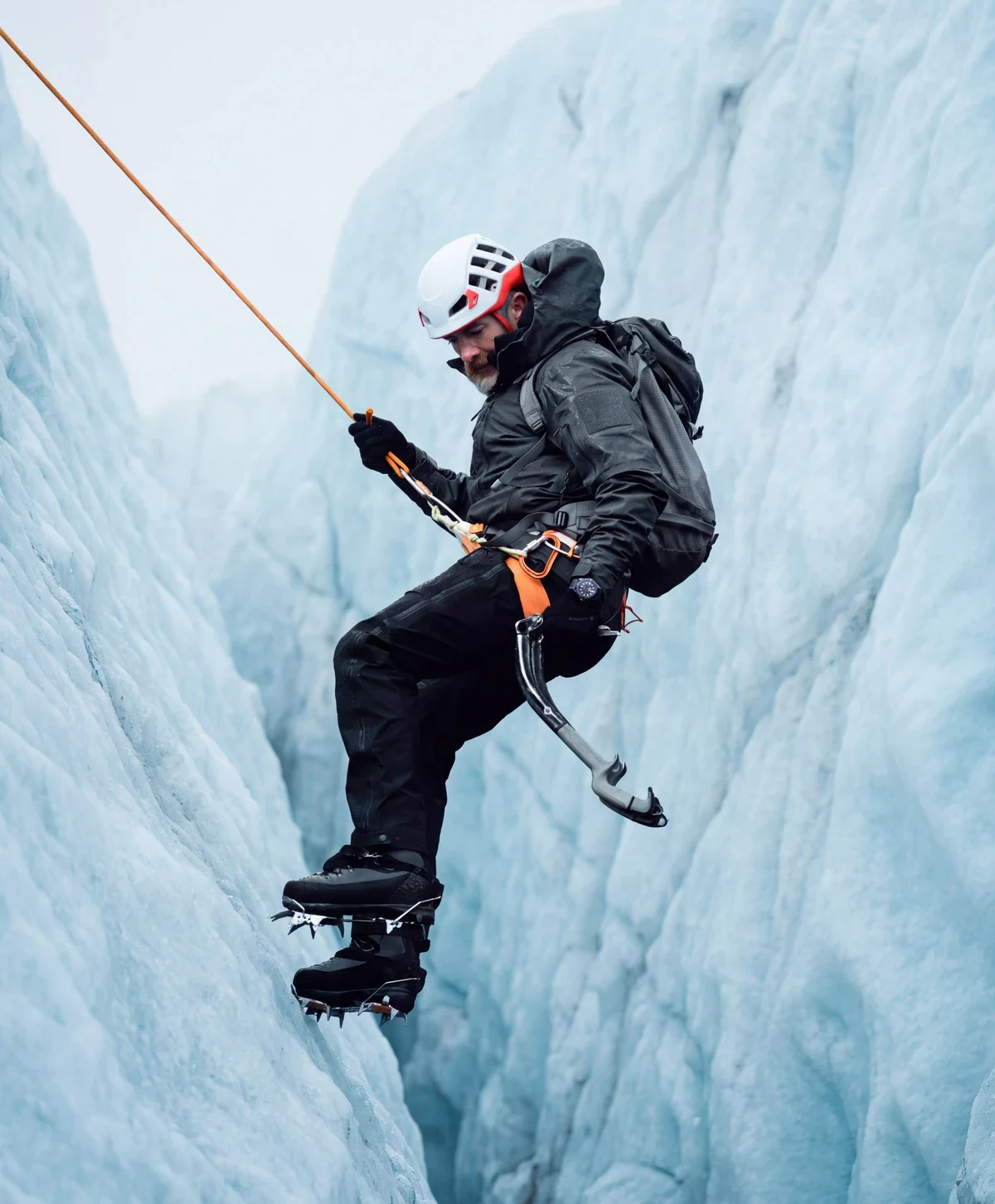 Bremont Supermarine Full Ceramic Deep Blue field test: Bremont Ambassador Aldo Kane climbs a blue ice wall in Iceland with ice axes and a rope