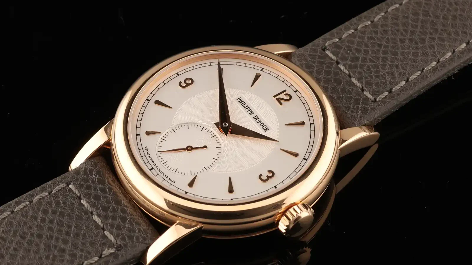 Philippe Dufour Simplicity auction lead lot: the 37mm rose gold Simplicity No. 199 with a silvered guilloché dial, gold Arabic numerals, and a grey leather strap