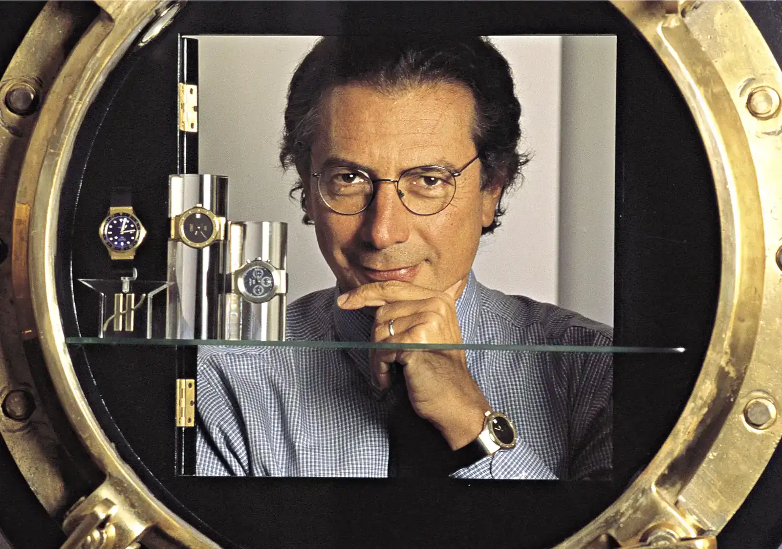 Archive portrait of Hublot founder Carlo Crocco framed by a gold porthole, the inspiration behind the Hublot Classic Fusion Tributo