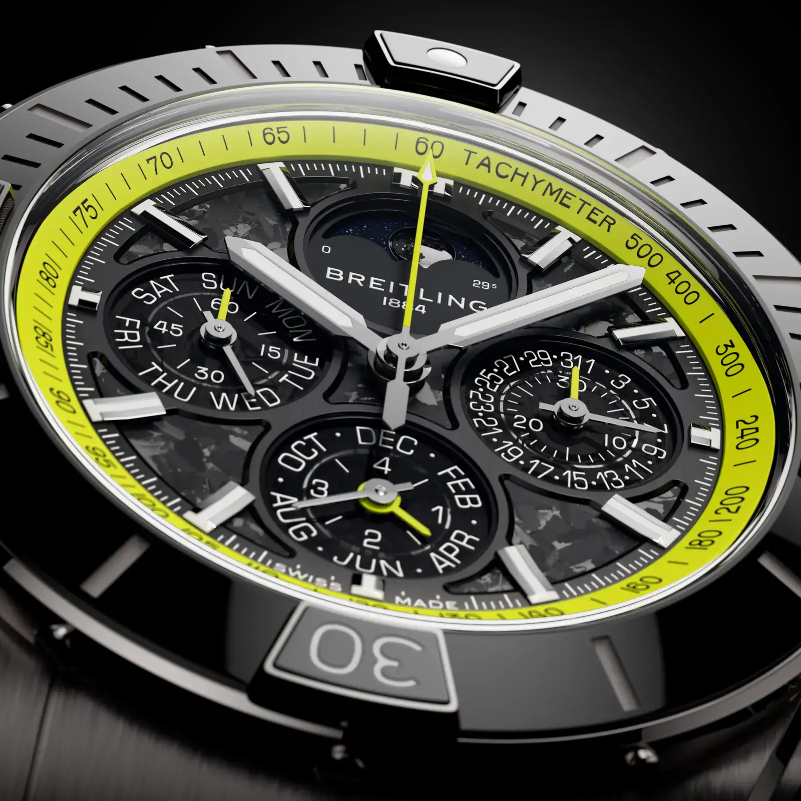 Close-up of the Breitling Super Chronomat Aston Martin Valhalla B19 44 Perpetual Calendar Chronograph carbon-fiber dial with Lime Green rehaut, moon phase and calendar subdials