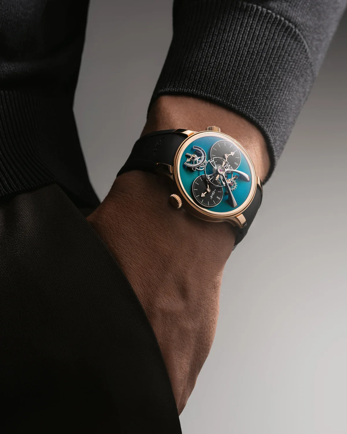 The rose gold MB&F LM1 EVO with green dial plate worn on the wrist
