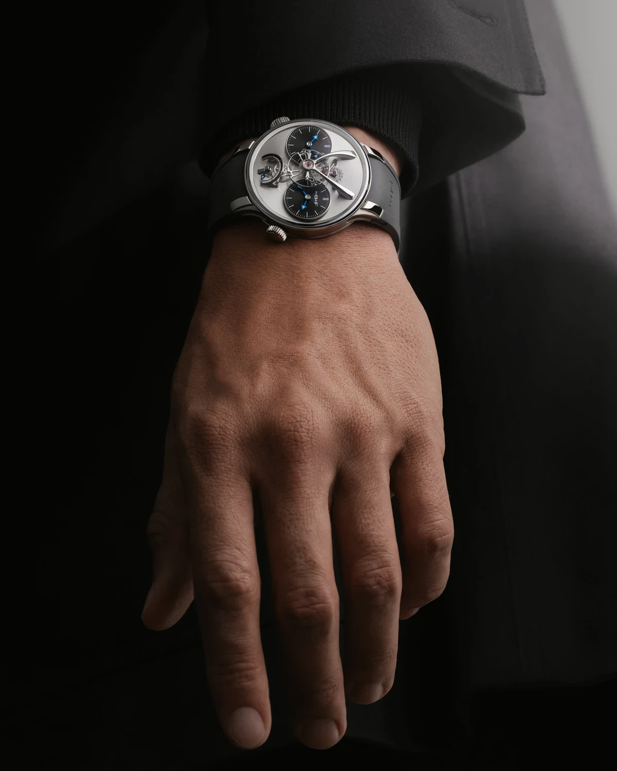 The titanium MB&F LM1 EVO worn on the wrist with a black rubber strap