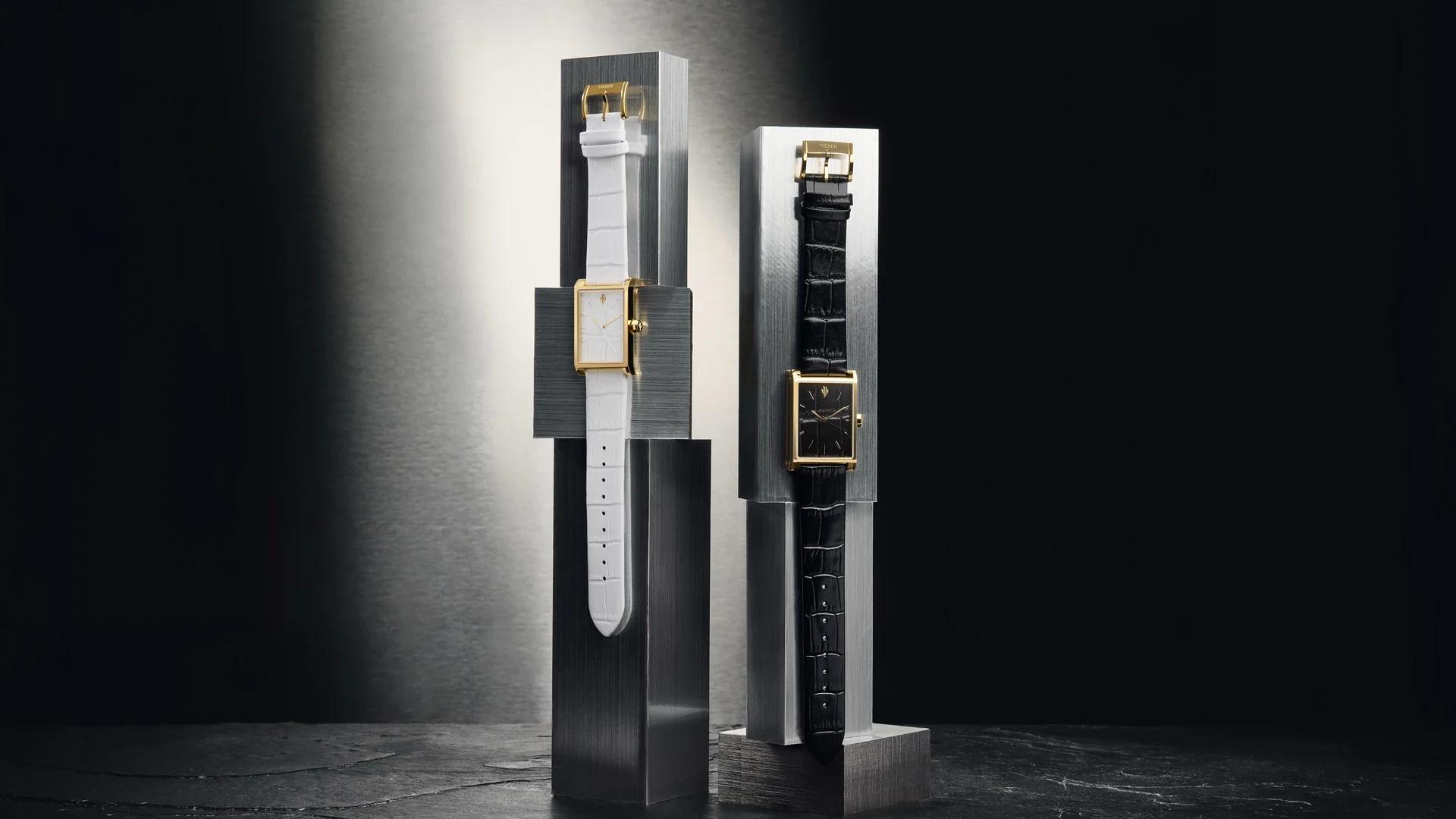 VIEREN Gold Croc in white and black crocodile-embossed leather, displayed side by side on brushed steel stands