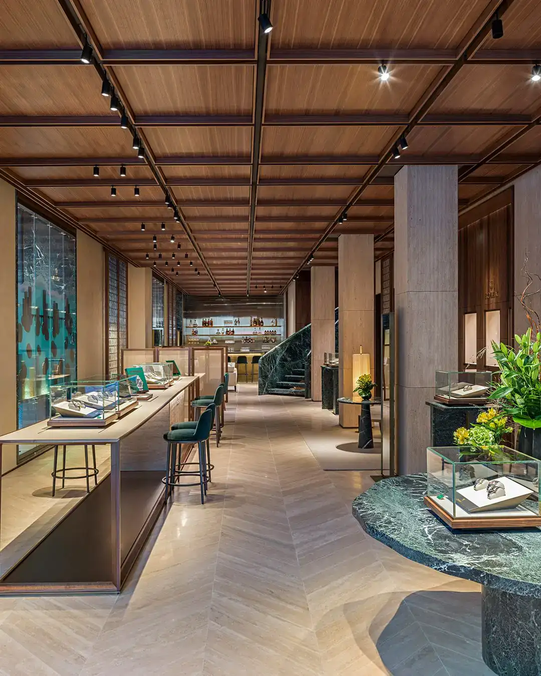 Ground-floor interior of the Rolex boutique in Paris with travertine and walnut finishes