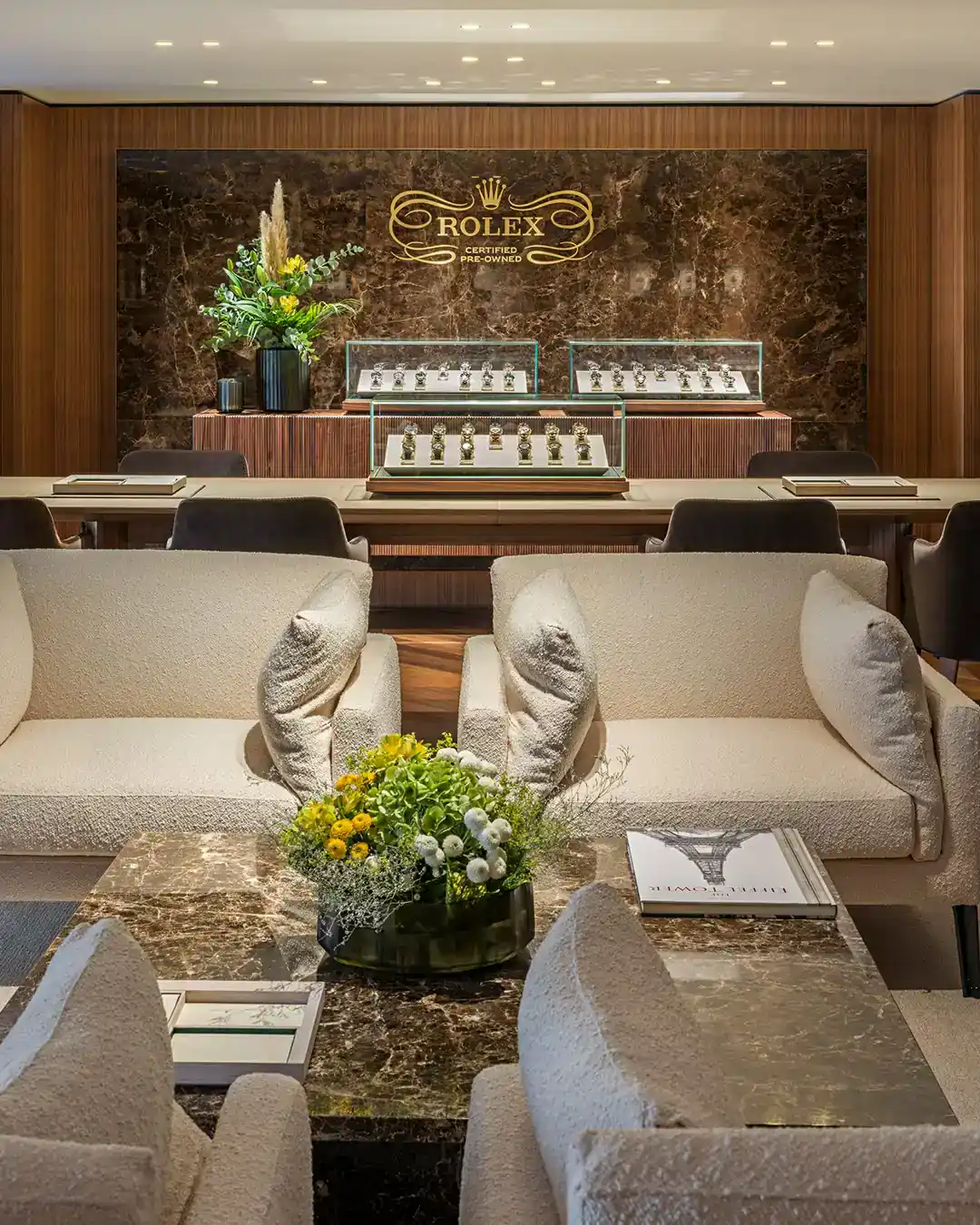 Seating area beneath the Rolex crown wall in the Rolex boutique Paris flagship