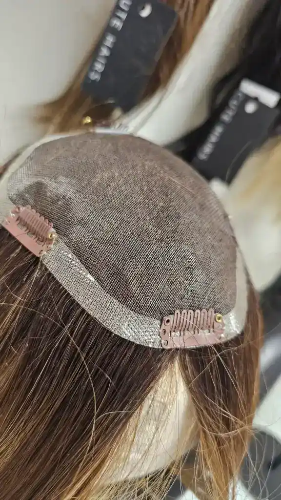 Lace front wig cap with adjustable straps and hair strands.