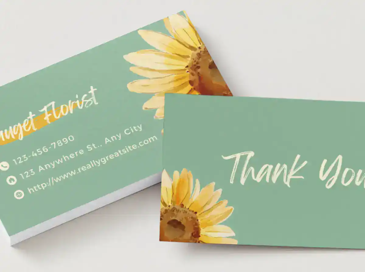 Business card with sunflower design and contact info for Handicap Sign Inc.