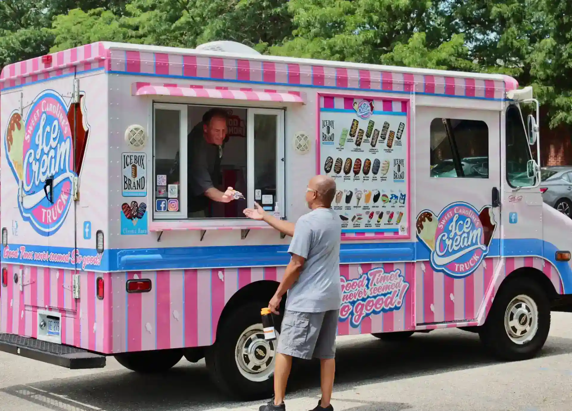 Ice Cream Truck serving Ice Box Brand ice cream bars to a customer.