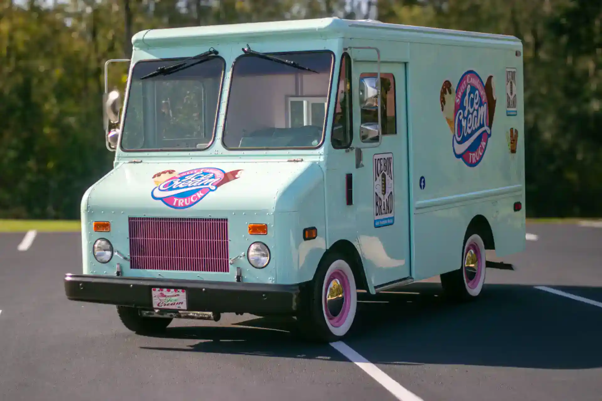 Ice Box Brand ice cream truck with logo and colorful design.