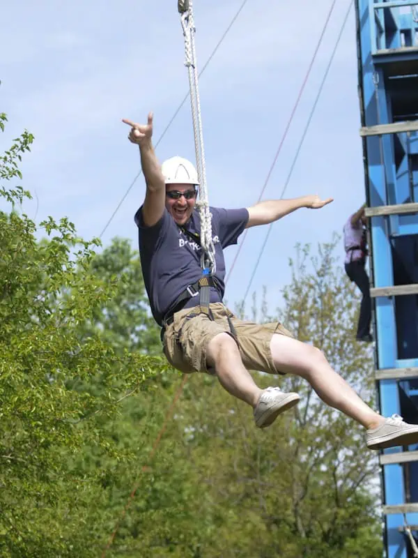 man riding zipline