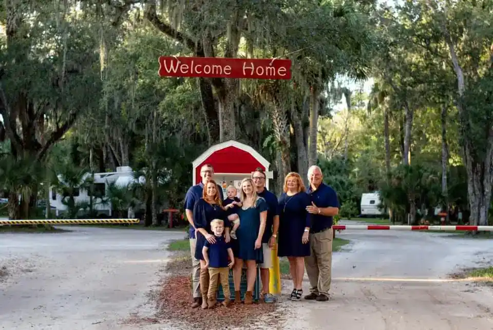 The family who owns Sugar Mill Ruins RV Park poses for a photo in front of the park.