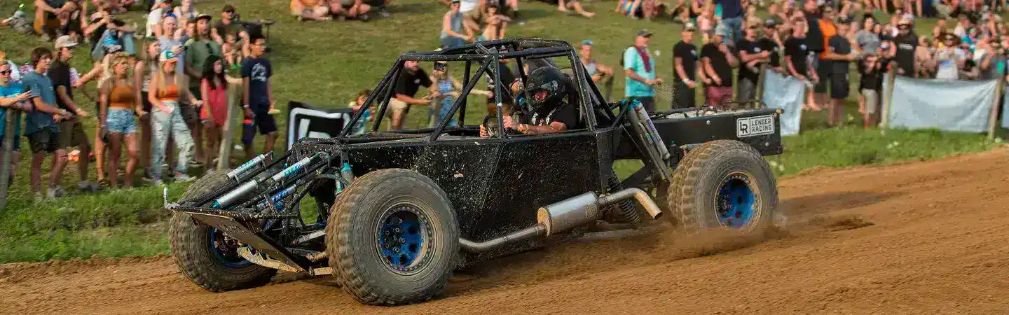 racing on dirt track in custom made side by side