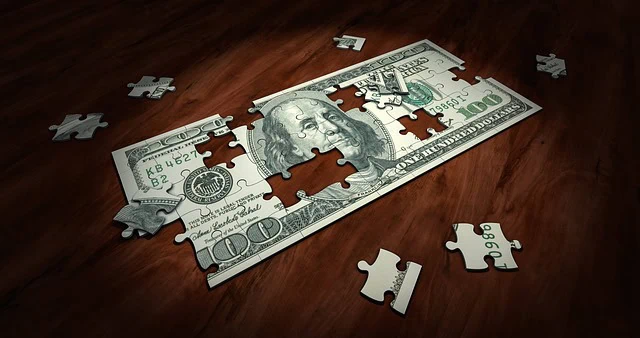 Puzzle piece containing a US hundred dollar bill, symbolising financial complexity and problem-solving.