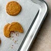 Savory Parmesan cookies with Espelette pepper on a parchment-lined baking sheet