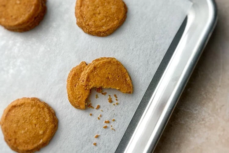 Savory Parmesan cookies with Espelette pepper on a parchment-lined baking sheet