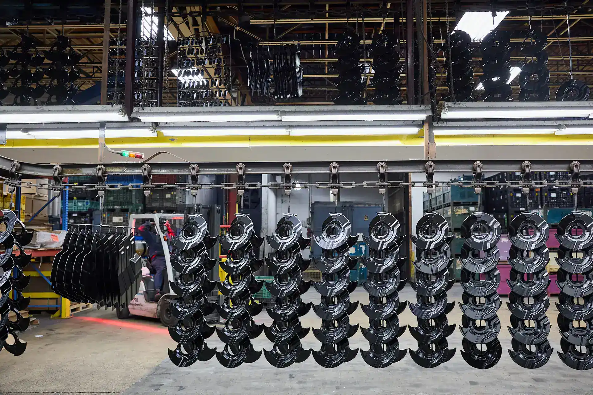Automotive parts manufacturing in a factory with organized machinery and equipment.