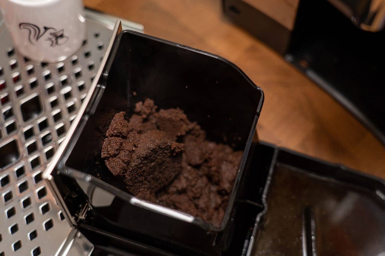 A closeup of the Philips 5400 LatteGo used grounds container.