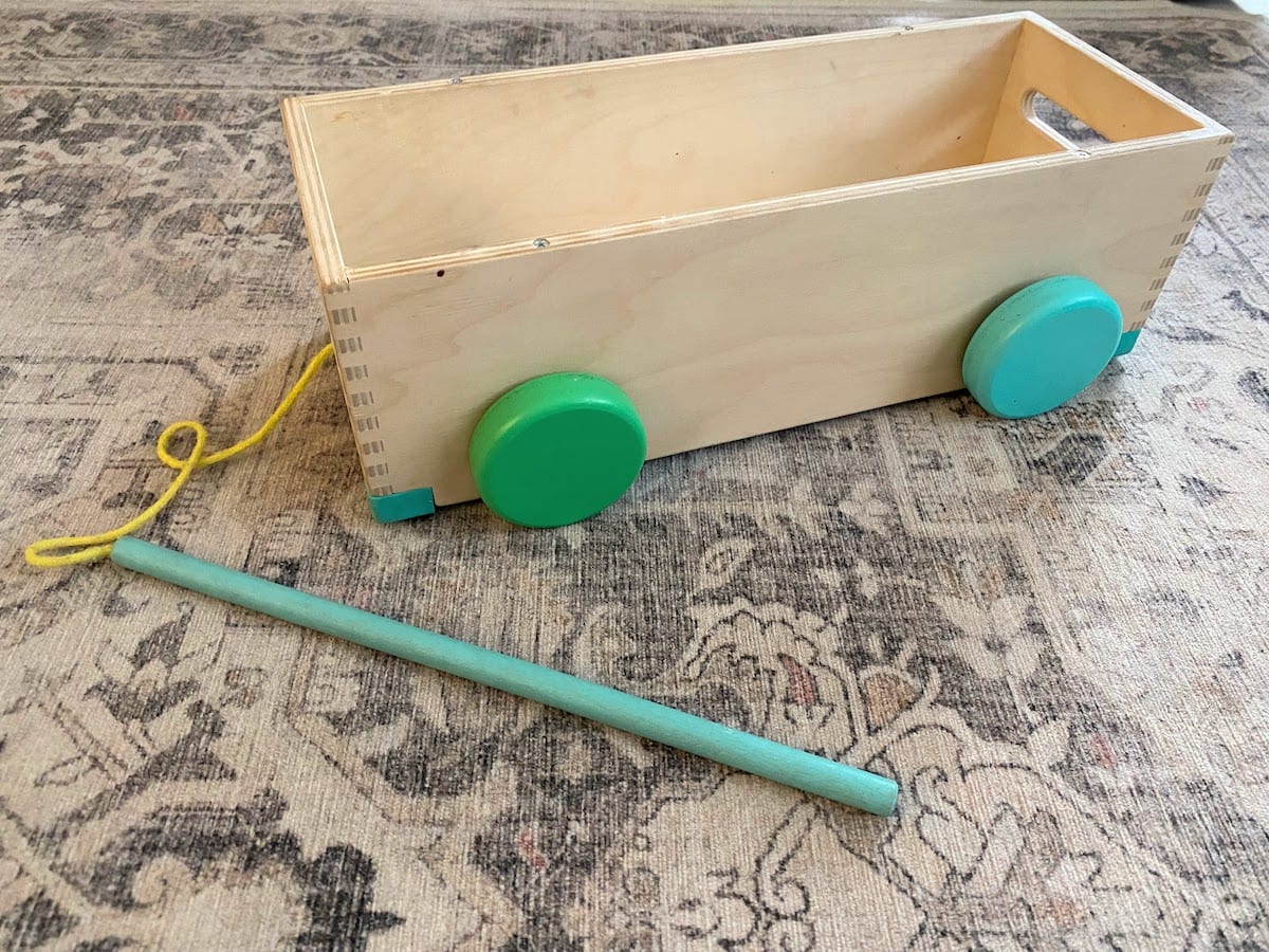 Lovevery blocks wooden storage box transformed into a pull car using the toggle on a string