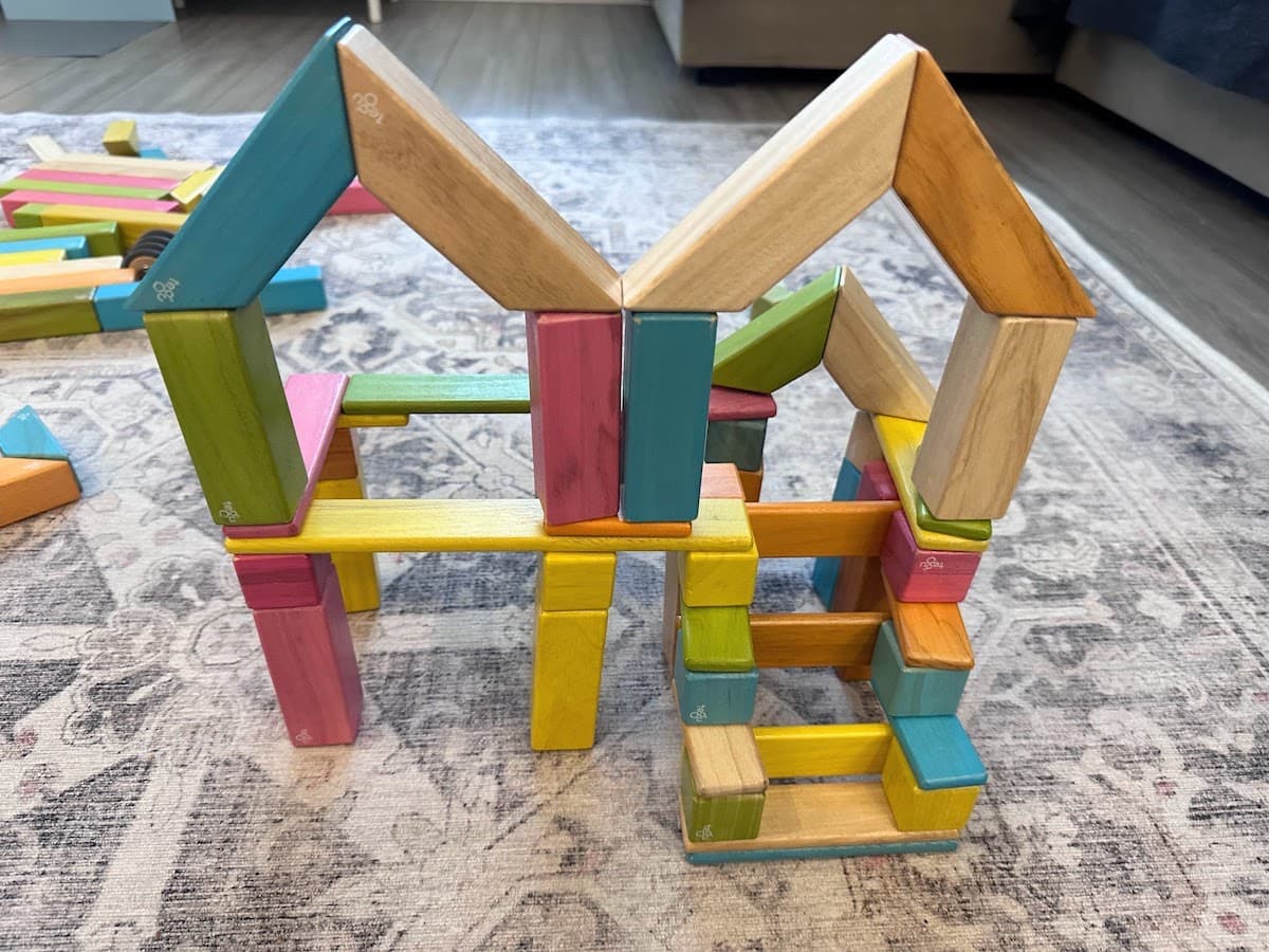 A small house with stairs built entirely with a Tegu magnetic wooden building block set