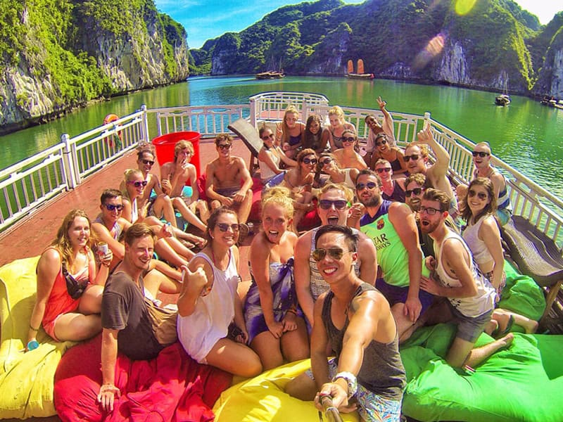 taking photos with friends on halong bay party cruise