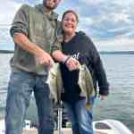 A man holds up two largemouth bass caught with Badock Fishing Guide Service while at Table Rock Lake in southwest Missouri near Branson.