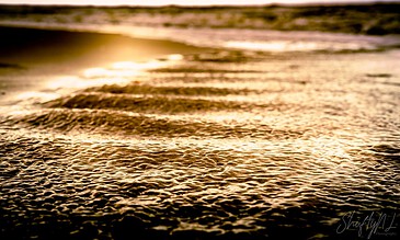 Vibrant sunset over ocean waves with shimmering reflections, capturing serene and majestic coastal beauty for stunning photography.