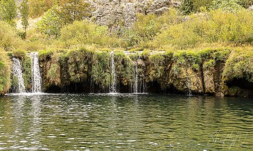 small waterfall at the end of the canyon