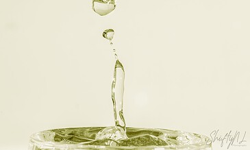 1. Close-up of water droplets splashing into a glass, showcasing high-speed photography and crystal-clear detail.