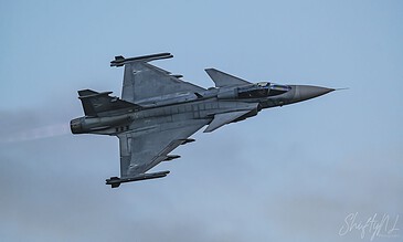 A sleek F-16 fighter jet captured in mid-flight, showcasing its aerodynamic design and power against a clear blue sky. F-16 fighter jet soaring through the sky during flight.