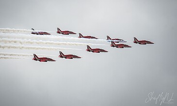 Spectacular formation flying by Aero L-39 Albatros jets, showcasing precision and skill in the sky, captured by ShiftyNL Photography. Aero L-39 Albatros jet aircraft flying in formation with smoke trails against a cloudy sky.