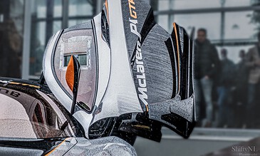 1. Close-up of a sleek racing car with a detailed view of the rear wing and aerodynamic features, capturing the essence of motorsport excellence.