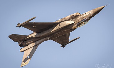 A close-up of a military F-16 fighter jet in flight against a bright blue sky, highlighting its streamlined shape and advanced aeronautical engineering. F-16 fighter jet soaring through a clear blue sky, showcasing sleek design and aerodynamic features. Perfect for aviation photography enthusiasts and military aircraft enthusiasts.