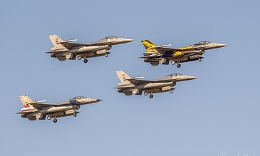 A stunning image of five fighter jets in tight formation, highlighting the power and agility of modern military aircraft in flight. Five fighter jets flying in formation against a clear blue sky, showcasing military aviation skills and precision.