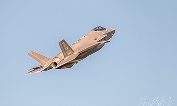 A sleek F-35 fighter jet in flight against a bright blue sky, highlighting modern aviation and military aircraft design. F-35 fighter jet soaring through clear blue sky, showcasing advanced military aircraft technology.